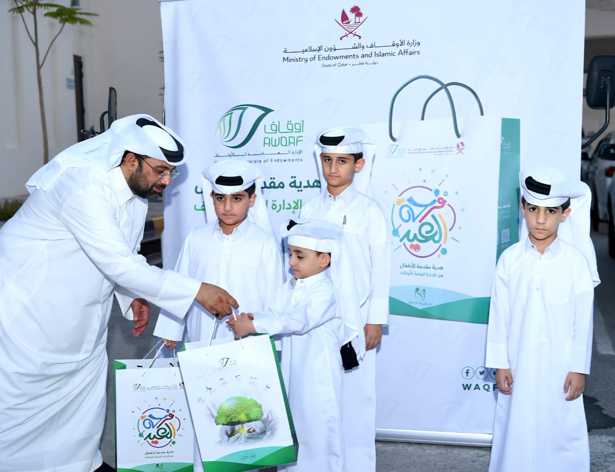 An official distributes gift to children during the Eid celebrations.