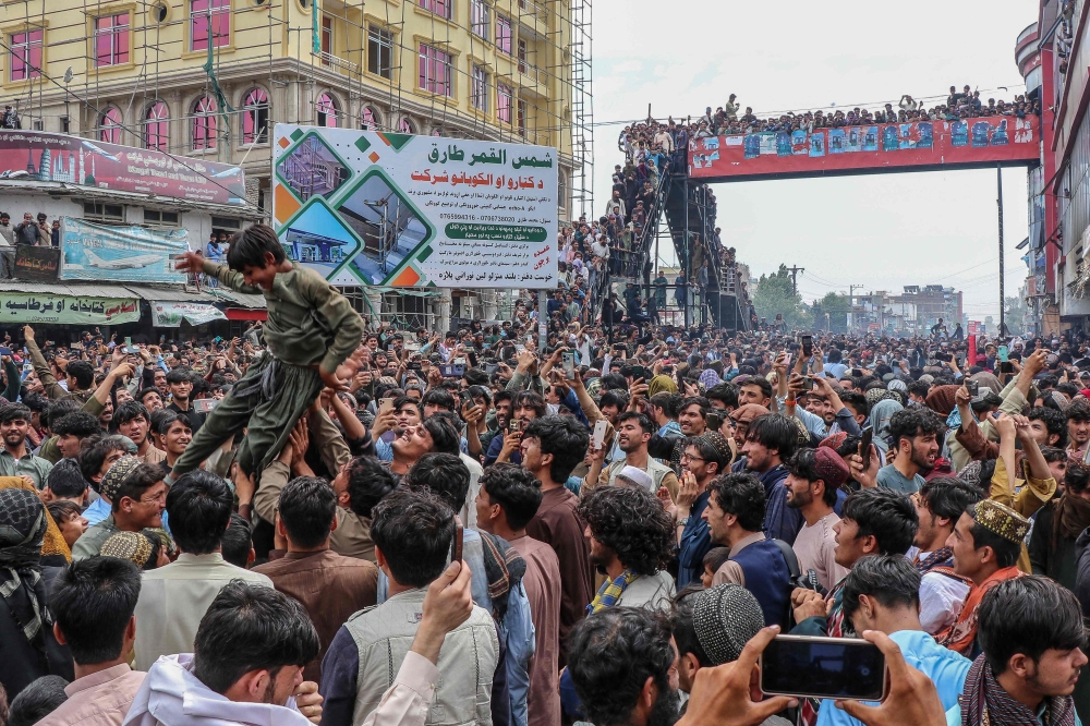 Afghan fans celebrate Afghanistan's win against Bangladesh during super eight match at the ICC T20 Cricket World Cup 2024, in Khost on June 25, 2024. (Photo by AFP)
