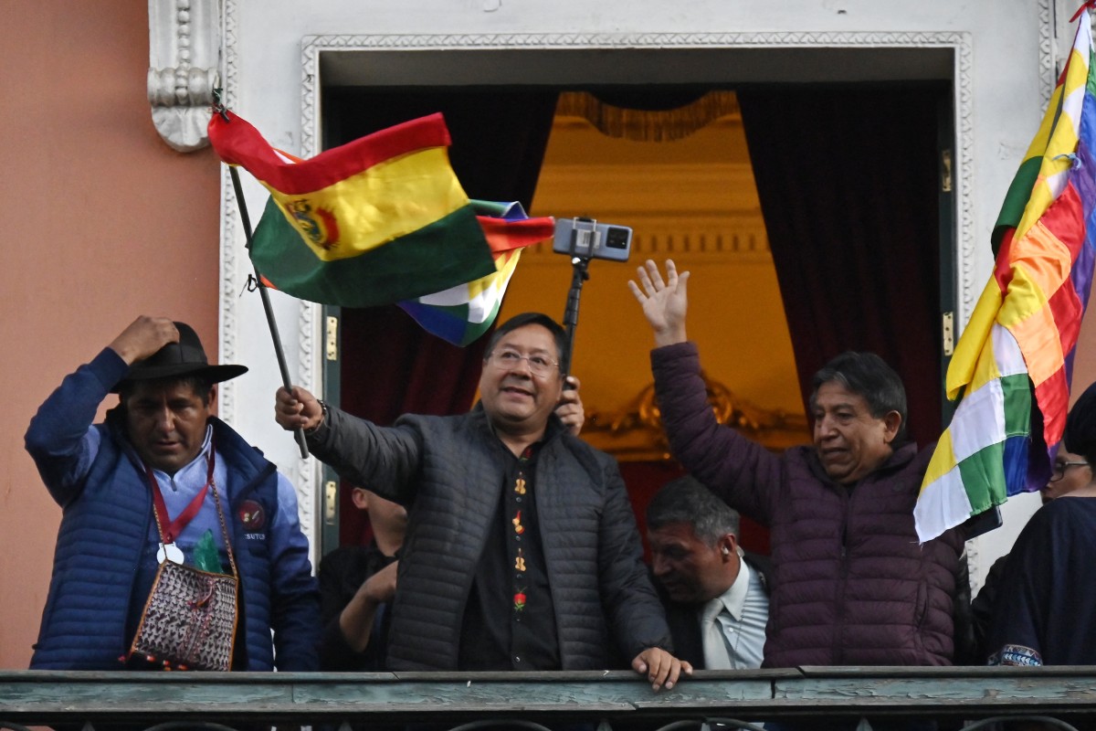 Bolivian President Luis Arce waves a Bolivian flag at the balcony of the Government Palace in La Paz on June 26, 2024. Photo by AIZAR RALDES / AFP.