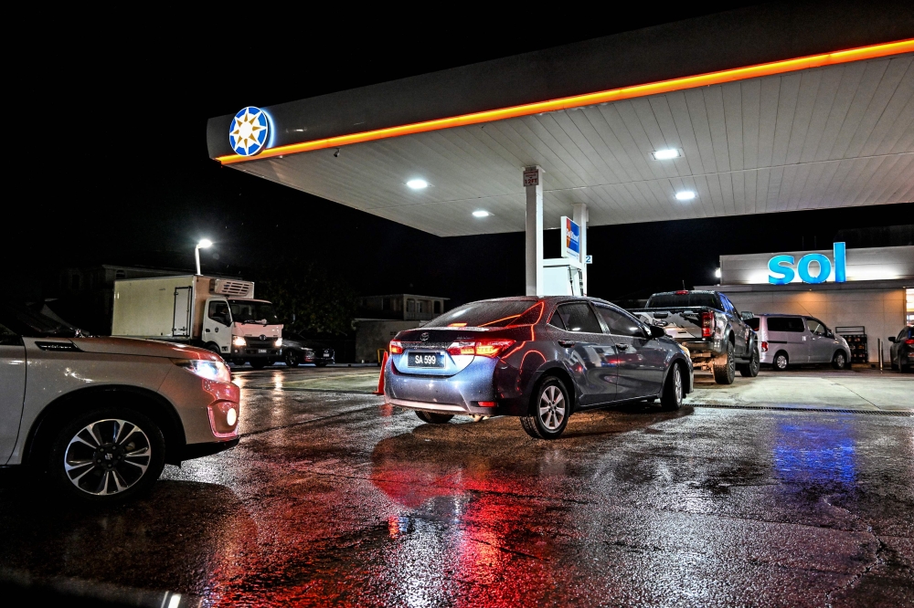 Car line up at a gas station before hurricane Beryl lands in Bridgetown, Barbados on June 29, 2024. (Photo by Chandan Khanna / AFP)