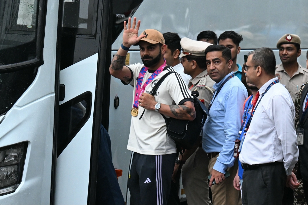 Indian cricket team member Virat Kohli gestures as he arrives at the Indira Gandhi international airport in New Delhi on July 4, 2024. (Photo by Money Sharma / AFP