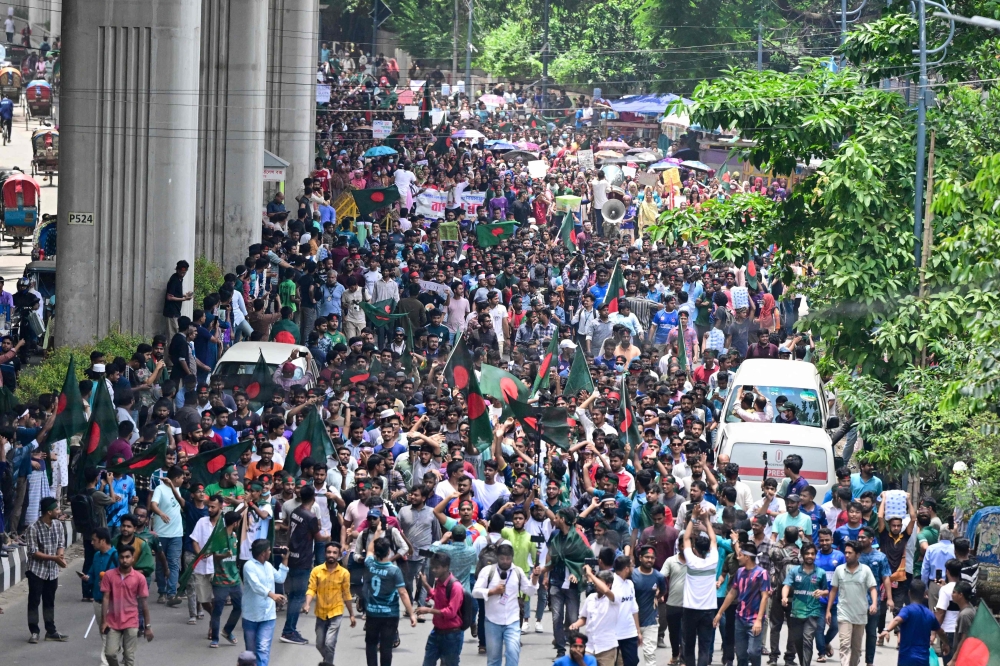 Students block roads as they protest to demand a merit-based system for civil service jobs in Dhaka on July 10, 2024. (Photo by Munir Uz Zaman / AFP)
 
