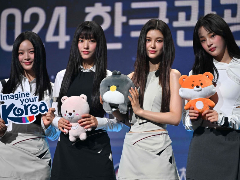 K-pop girl group 'NewJeans' members (L-R) Hanni, Haerin, Danielle and Minji pose for photos during an appointment ceremony of the 2024 Korea Tourism Honorary Ambassador at a hotel in Seoul on July 11, 2024. (Photo by Jung Yeon-je / AFP)
