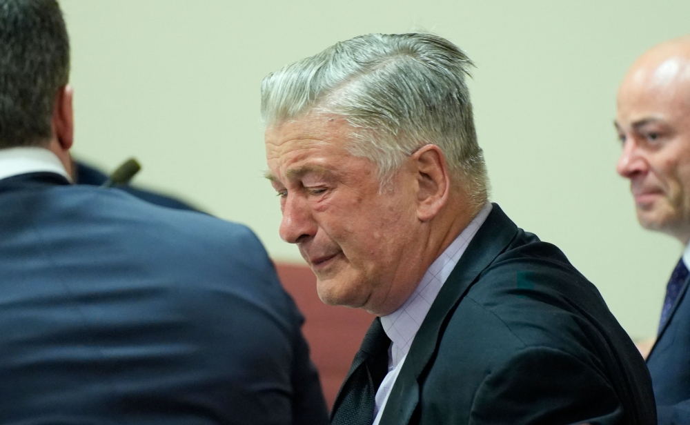 US actor Alec Baldwin reacts as he sits between his attorneys Alex Spiro (L) and Luke Nikas (R) at the conclusion of his trial on involuntary manslaughter at Santa Fe County District Court in Santa Fe, New Mexico, on July 12, 2024. (Photo by RAMSAY DE GIVE / POOL / AFP)
