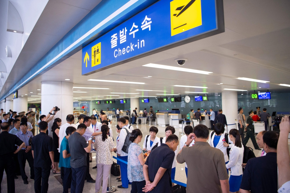 North Korea players leave to take part in the Paris 2024 Olympic Games, at the Pyongyang International Airport in Pyongyang on July 20, 2024. (Photo by Kim Won Jin / AFP)
 