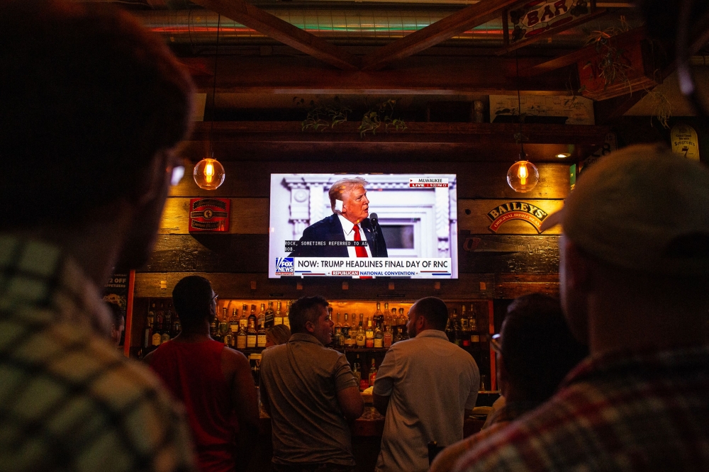 People watch as Donald Trump's GOP candidate acceptance speech is broadcast inside a bar on the final night of the RNC on July 18, 2024 in Milwaukee, Wisconsin. (Photo by Jim Vondruska / GETTY IMAGES NORTH AMERICA / Getty Images via AFP)
