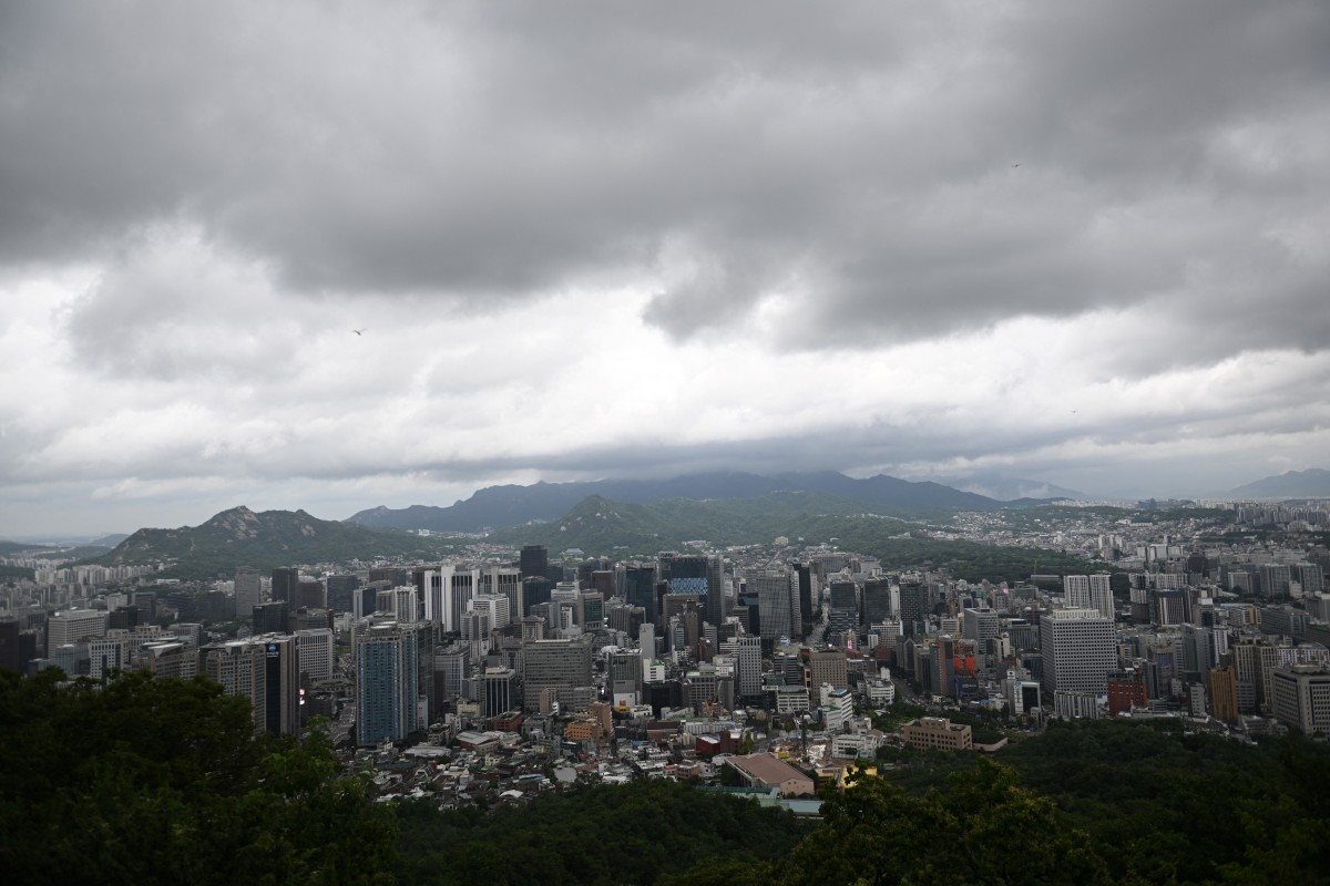 A general view shows the city skyline after heavy rain as seen from the landmark Namsan Tower in central Seoul on July 17, 2024. (Photo by Jung Yeon-je / AFP)