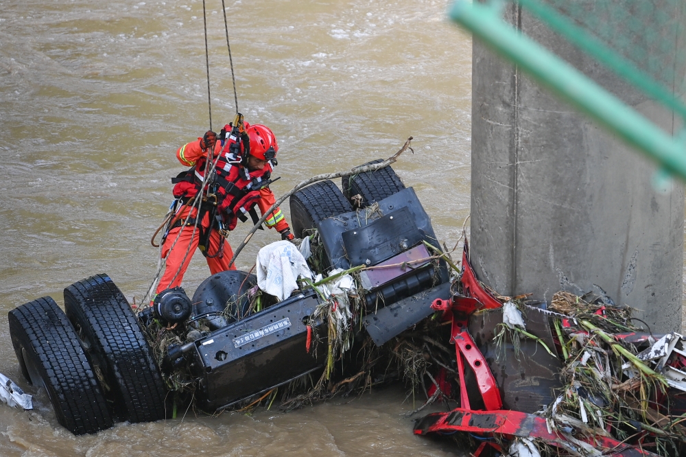 A rescuer works at the site of a bridge collapse in Zhashui County in Shangluo City, northwest China's Shaanxi Province, July 21, 2024. Xinhua/Zou Jingyi