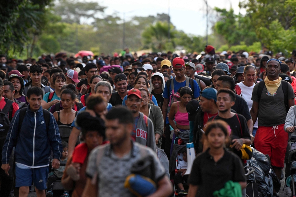 Hundreds of migrants, mostly from Central America, set out in a US-bound caravan to escape poverty and violence, on the outskirts of Tapachula, State of Chiapas, Mexico, on July 23, 2024. (Photo by ISAAC GUZMAN / AFP)

