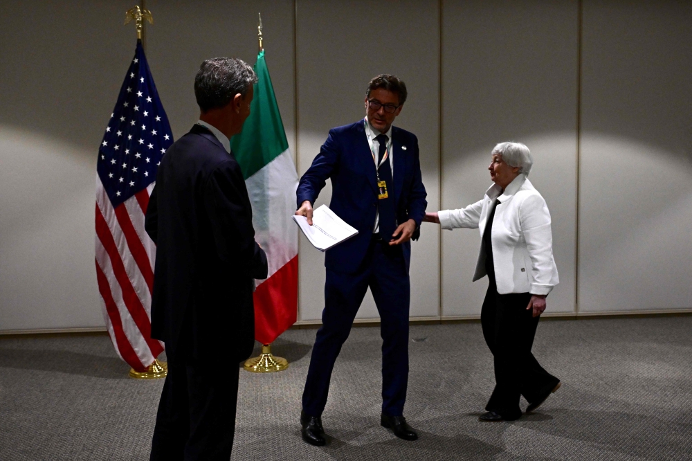 US Treasury Secretary Janet Yellen (right) and Italy's Minister of Economy and Finance Giancarlo Giorgetti (center) are pictured ahead of a bilateral meeting in the framework of the G20 Ministerial Meeting in Rio de Janeiro, Brazil, on July 25, 2024. (Photo by Pablo Porciuncula / AFP)