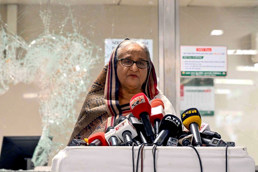 In this handout photograph taken and released on July 25, 2024 by Bangladesh Prime Minister's Office, Prime Minister Sheikh Hasina addresses the media at a vandalized metro station in Mirpur, after the anti-quota protests. (Photo by Bangladesh Prime Minister's Office / AFP)
