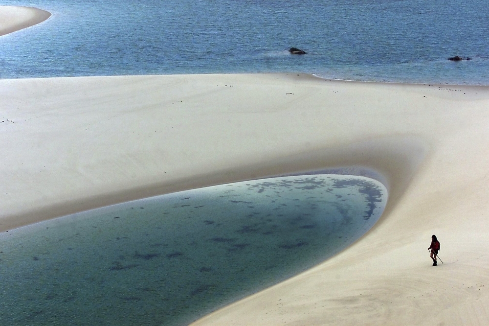 (FILES) A member of a team taking part in the Elf Authentique Aventure raid crosses the Lençَis Maranhenses National Park in Maranhمo State, northeastern Brazil, on April 25, 2000. (Photo by Joël SAGET / AFP)
