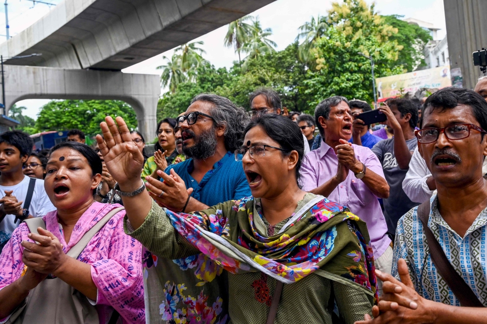 People take part in a song march to protest against the indiscriminate killings and mass arrest in Dhaka on July 26, 2024. (Photo by Munir Uz Zaman / AFP)