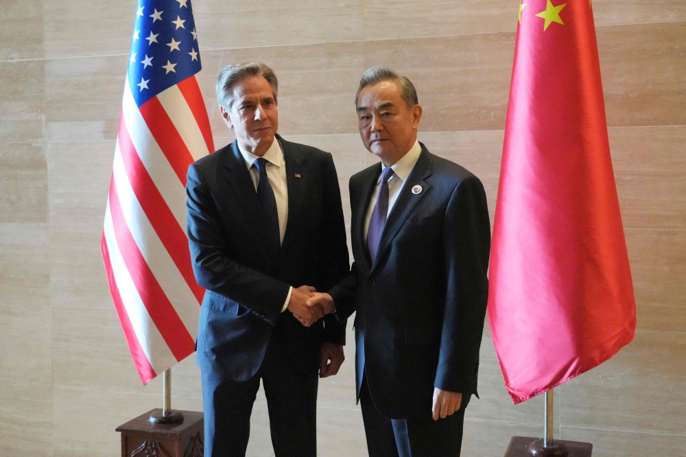 US Secretary of State Antony Blinken (L) shakes hands with China's Foreign Minister Wang Yi on July 27, 2024. (Photo by Achmad Ibrahim / POOL / AFP)