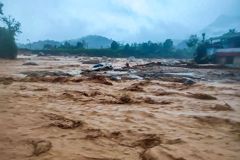 A handout photograph taken on July 30, 2024 shows a damaged car at the landslide site in Wayanad. (All photos by National Disaster Response Force (NDRF) / AFP)
