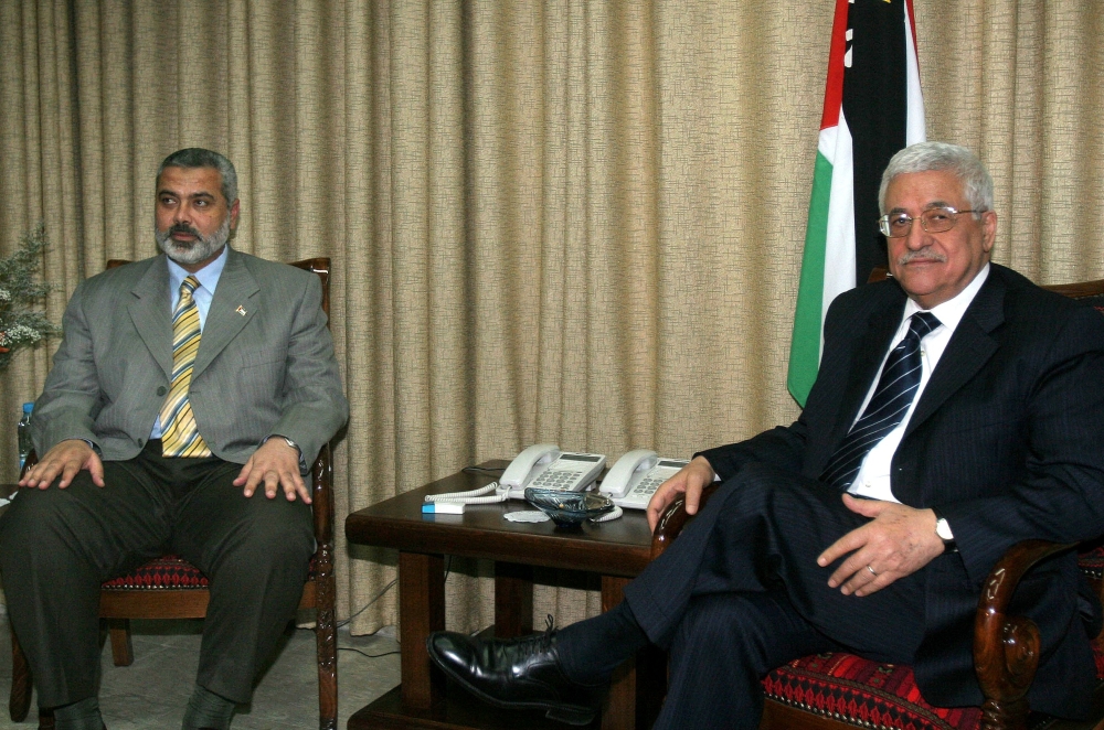 (Files) Palestinian Authority President Mahmoud Abbas (R) meets with Ismail Haniyeh at Abbas' office in Gaza City, Saturday, June 10, 2006. (Photo by Khalil Hamra / AFP)