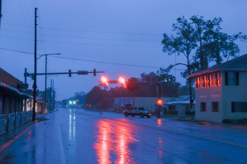 Wind and rain kicked up by Hurricane Debby blow through a street on August 05, 2024 in Chiefland, Florida. (Photo by JOE RAEDLE / GETTY IMAGES NORTH AMERICA / Getty Images via AFP)
