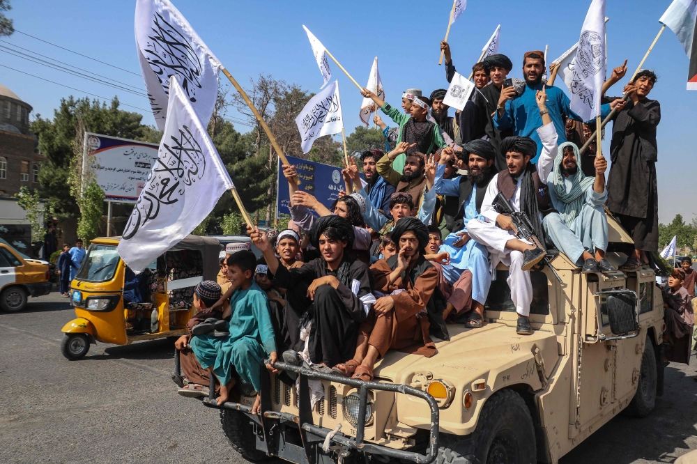 A convoy of Taliban security personnel seen moving along the streets as they celebrate the third anniversary of Taliban takeover of Afghanistan, in Herat on August 14, 2024. (Photo by Mohsen KarimI / AFP)
