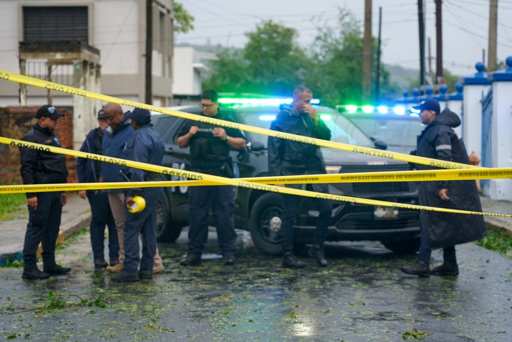 Police block a flooded road in Fajardo, Puerto Rico, as Tropical Storm Ernesto passes through the area on August 14, 2024. (Photo by Jaydee Lee SERRANO / AFP)

