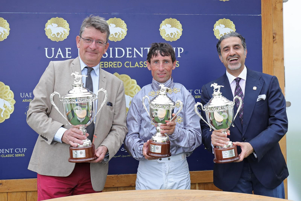 The connections of Al Shaqab Racing's Luwsail pose with their trophies after winning the UAE President Cup. 