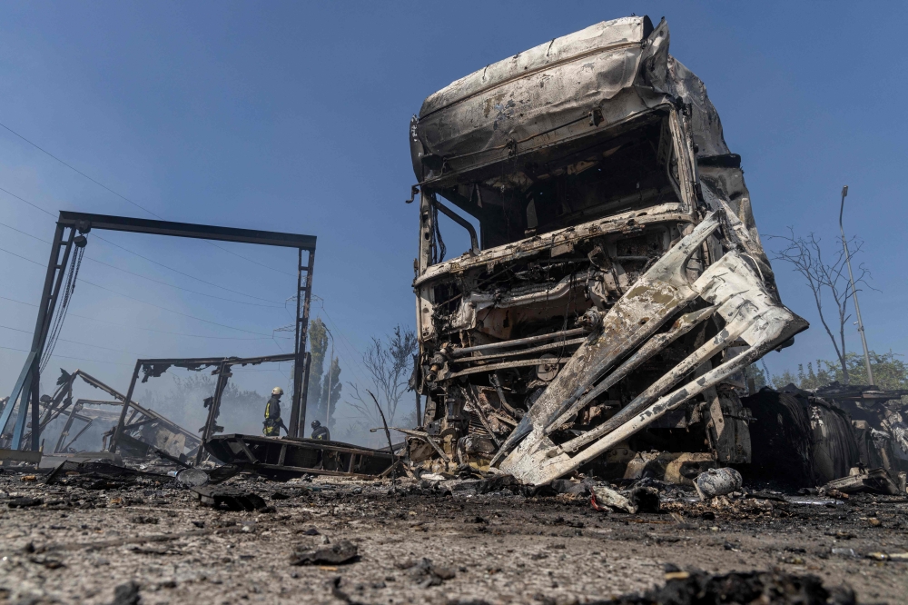 Ukrainian firefighters extinguish a fire on a site following an air attack, in the Odesa region, on August 26, 2024. (Photo by Oleksandr GIMANOV / AFP)
