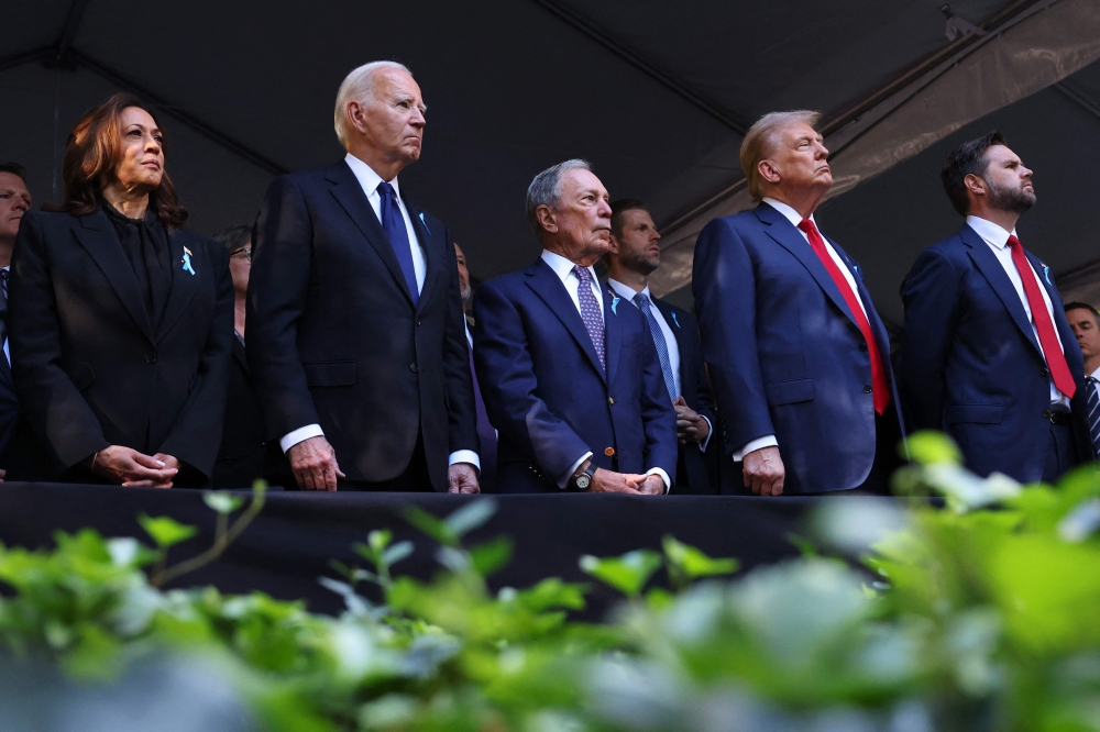 Democratic presidential nominee, US Vice President Kamala Harris, US President Joe Biden, former NYC Mayor Michael Bloomberg, former US President Donald Trump and Republican vice presidential nominee, US Senator JD Vance attend the annual 9/11 Commemoration Ceremony at the National 9/11 Memorial and Museum on September 11, 2024 in New York City. (Photo by Michael M Santiago/Getty Images via AFP)
