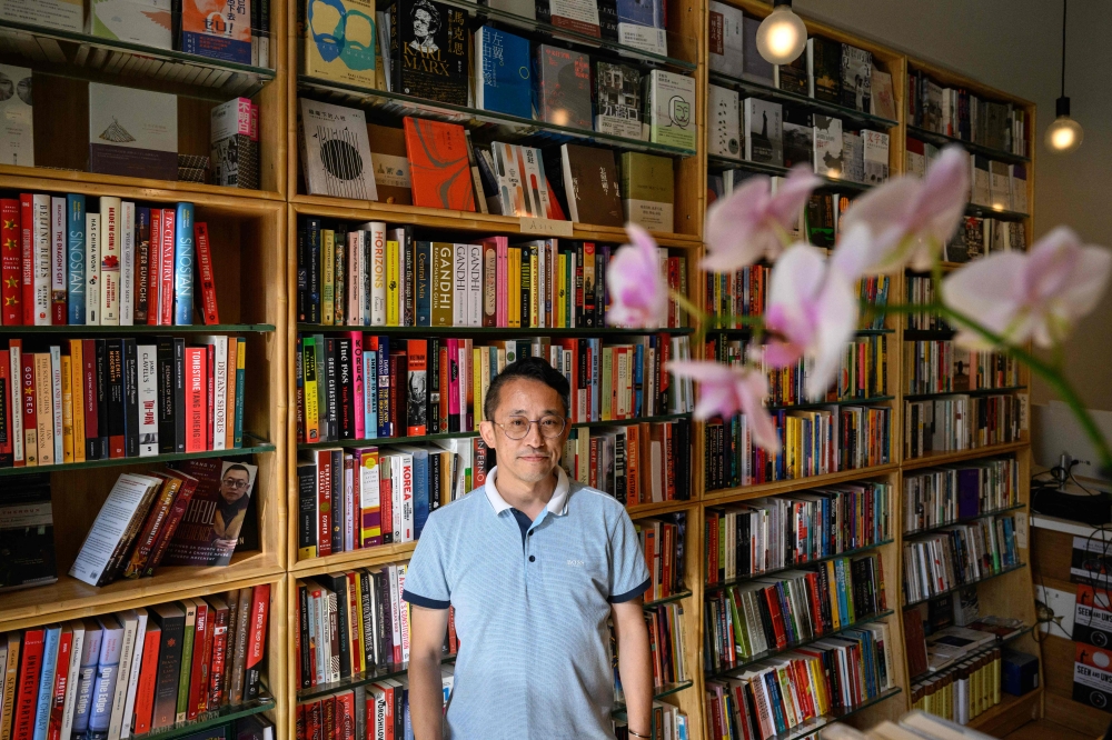 Yu Miao, owner of JF Books, poses for a portrait at his bookstore in Washington, DC, on September 6, 2024. (Photo by Drew Angerer / AFP)