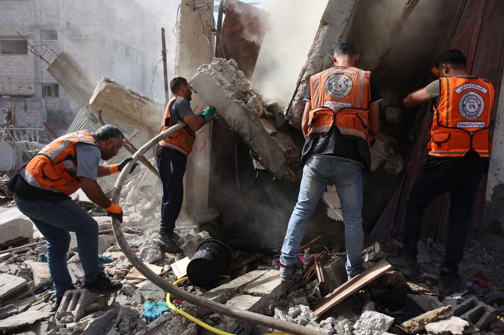 Palestinian civil defence rescue workers battle a fire after an Israeli strike in Gaza City on September 17, 2024, amid the continuing war between Israel and Hamas. (Photo by Omar AL-QATTAA / AFP)
