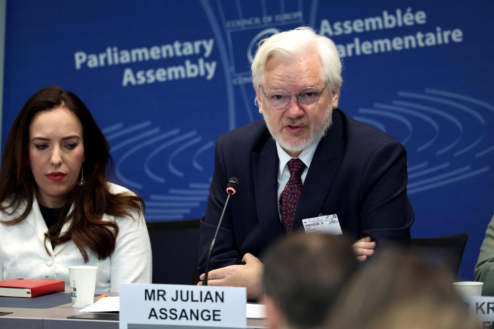 WikiLeaks founder Julian Assange, next to his wife Stella Assange, speaks during a parliamentary hearing at the Council of Europe in Strasbourg, eastern France, on October 1, 2024. (Photo by Frederick Florin / AFP)