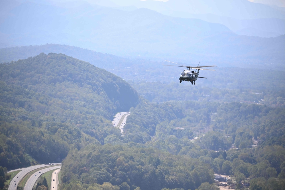 Marine One, carrying US President Joe Biden flies above a storm impacted area near Asheville, North Carolina, on October 2, 2024. (Photo by Mandel Ngan / AFP)
