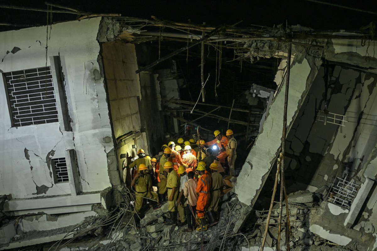 National Disaster Response Force (NDRF) personnel inspect the site for survivors during a search operation after an under-construction building collapsed in Bengaluru on October 22, 2024. Photo by Idrees MOHAMMED / AFP.
