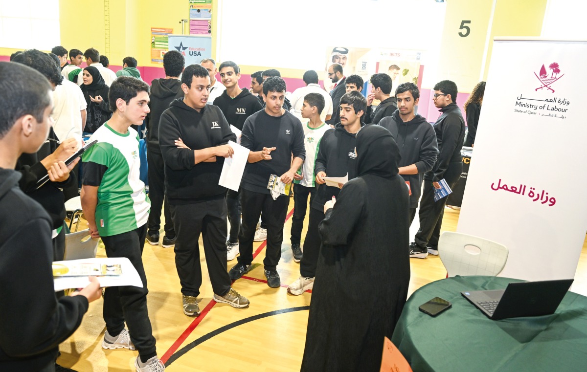 Students interacting with a Ministry of Labour official at the career fair.
