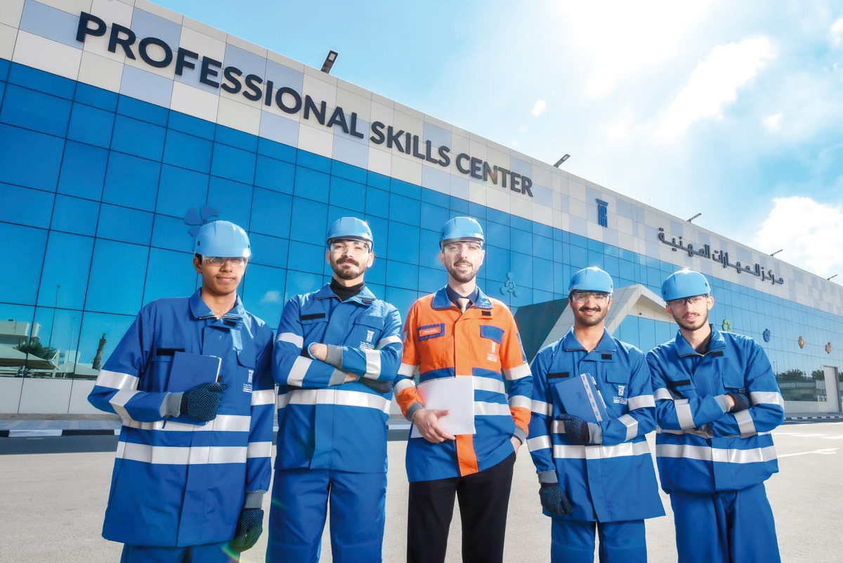 A group of UDST students pose for photo in front of the university's Professional Skills Center.