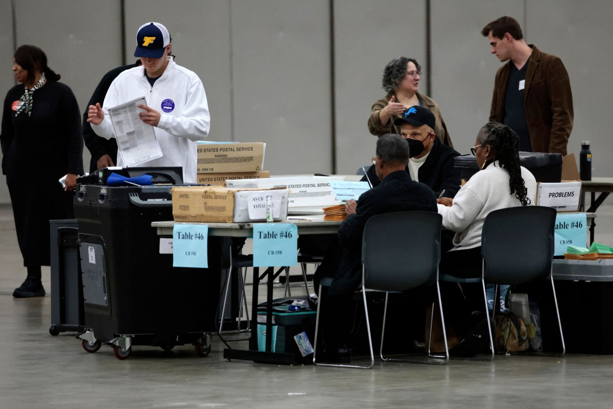 Workers process absentee ballots for the 2024 General Election at Huntington Place on November 5, 2024 in Detroit, Michigan. (Photo by JEFF KOWALSKY / AFP)
