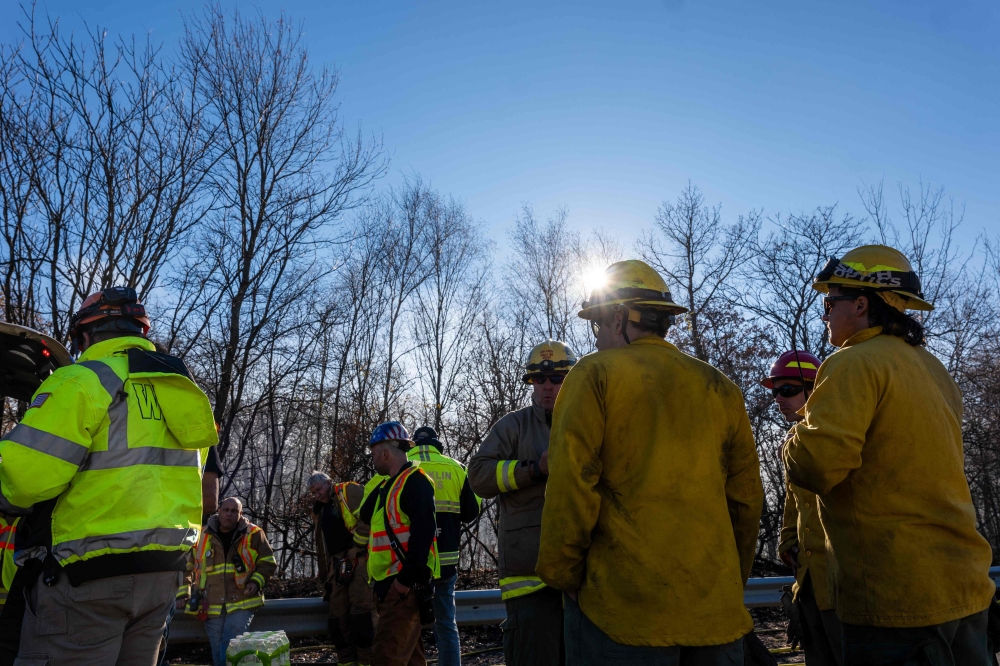 Firefighters take a break from battling a series of brush fires on November 09, 2024 outside of Pompton Lakes, New Jersey. Photo by SPENCER PLATT / GETTY IMAGES NORTH AMERICA / Getty Images via AFP