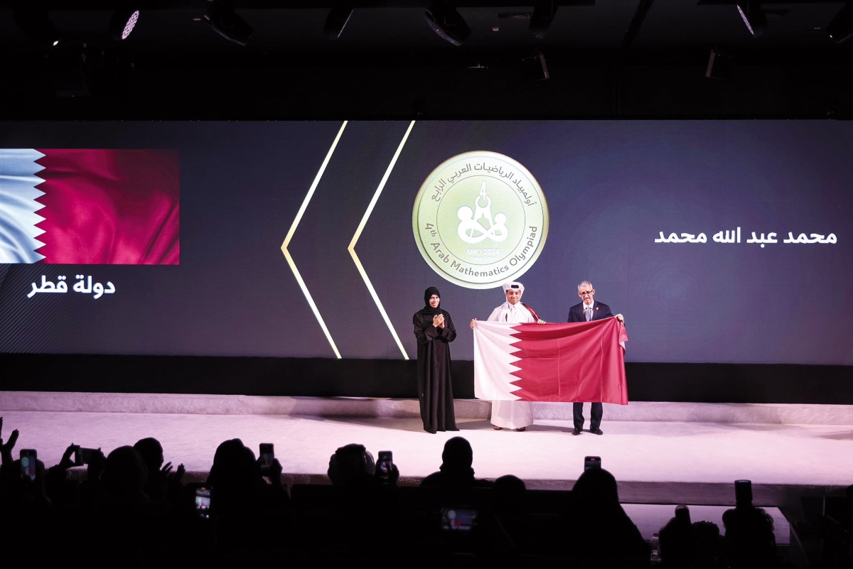 Minister of Education and Higher Education H E Lolwah bint Rashid Al Khater (left) honouring a winner at the conclusion of 4th Arab Mathematics Olympiad 2024 in Doha yesterday.