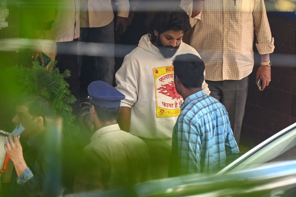 Indian actor Allu Arjun (centre) comes out of the Chikkadpally police station following his arrest by the police in Hyderabad on December 13, 2024. (Photo by Noah Seelam / AFP)
