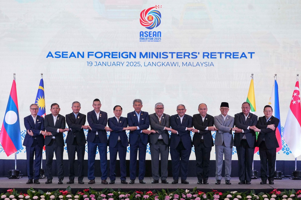 From L-R: Laos Minister of Foreign Affairs Thongsavanh Phomvihane, Myanmar's Permanent Secretary to ASEAN Aung Kyaw Moe, Singapore's Minister of Foreign Affairs Vivian Balakrishnan, Thailand's Minister of Foreign Affairs Maris Sangiampongsa, Vietnam's Deputy Prime Minister and Minister of Foreign Affairs Bui Thanh Son, Malaysia's Minister of Foreign Affairs Mohamad Hasan, Philippines's Secretary for Foreign Affairs Enrique A. Manalo, Brunei's Minister of Foreign Affairs Erywan Pehim Yusof, Cambodia's Secretery of State Kung Phoak, Indonesia's Minister for Foreign Affairs Sugiono, East Timor's Minister of Foreign Affairs Bendito Freitas, and ASEAN Secretary General Kao Kim Hourn pose for a group photo during the Association of Southeast Asian Nations (ASEAN) Foreign Ministers' Retreat in Malaysia's Langkawi Island on January 19, 2025. (Photo by Azneal Ishak / POOL / AFP)