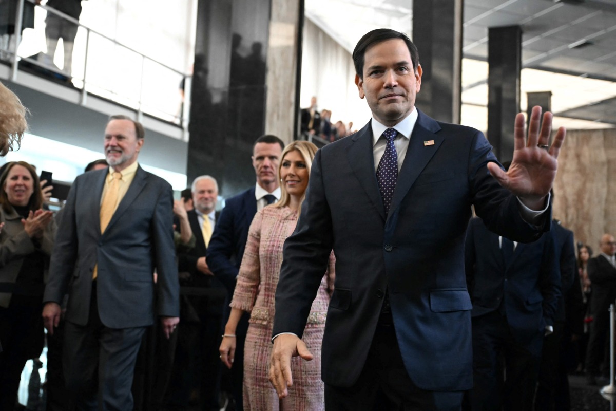 (FILES) US Secretary of State Marco Rubio and his wife Jeanette Rubio arrive to speak to employees upon arrival at the State Department in Washington, DC, on January 21, 2025. (Photo by ANDREW CABALLERO-REYNOLDS / AFP)
