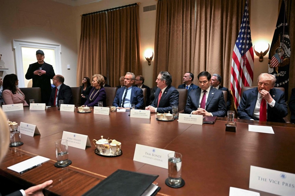 Leader of the Department of Government Efficiency Elon Musk (L) speaks during a cabinet meeting with US President Donald Trump (R) at the White House in Washington, DC, on February 26, 2025. (Photo by Jim Watson / AFP)