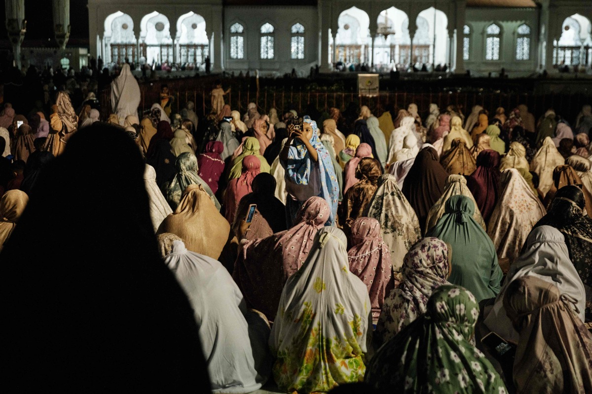 Muslim women offer first Tarawih prayers to mark the start of the Islamic holy fasting month of Ramadan, at Baiturrahman Grand Mosque in Banda Aceh on February 28, 2025. (Photo by YASUYOSHI CHIBA / AFP)
