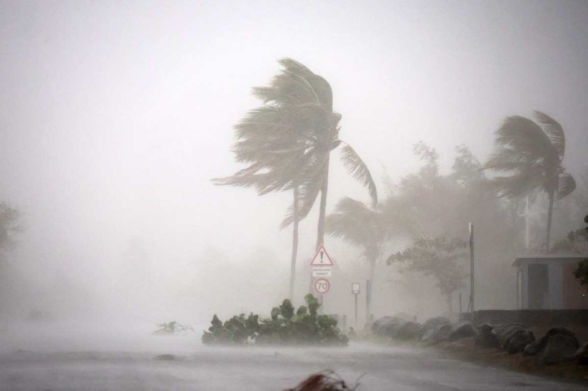 This photograph shows the passage of rain and wind across a road in Saint-Paul de La Reunion, on the French overseas Indian Ocean island of La Reunion, on February 28, 2025. Photo by Richard BOUHET / AFP.
