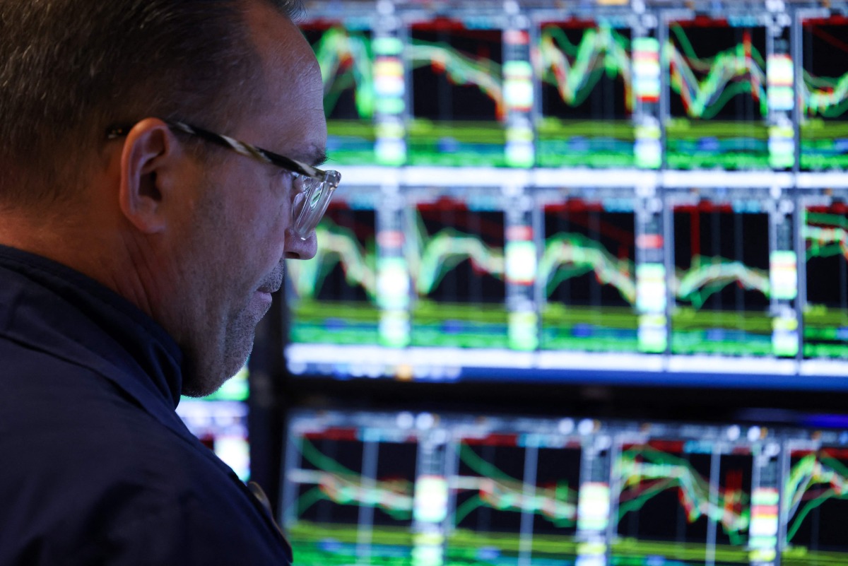 A trader works on the floor of the New York Stock Exchange (NYSE) at the opening bell in New York City on March 10, 2025. (Photo by CHARLY TRIBALLEAU / AFP)
