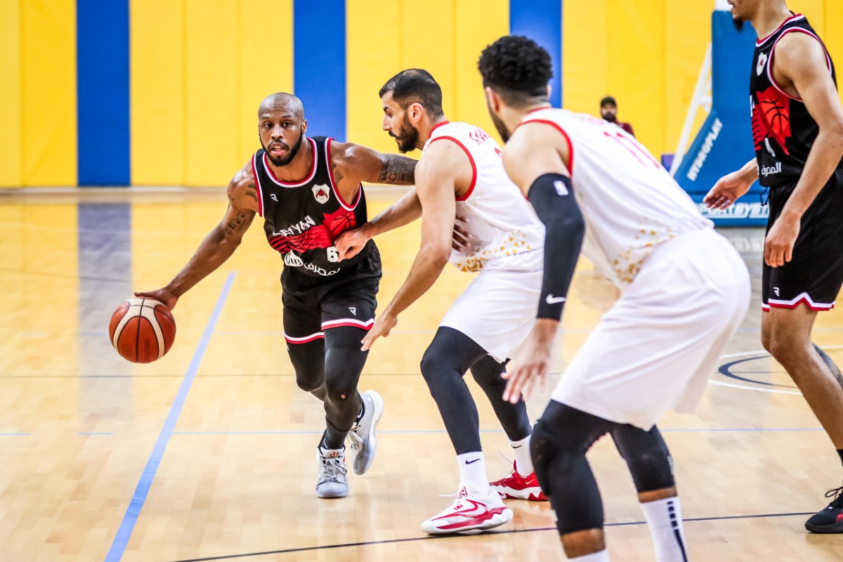 Al Rayyan's Darius Tyran Clark (left) dribbles. 