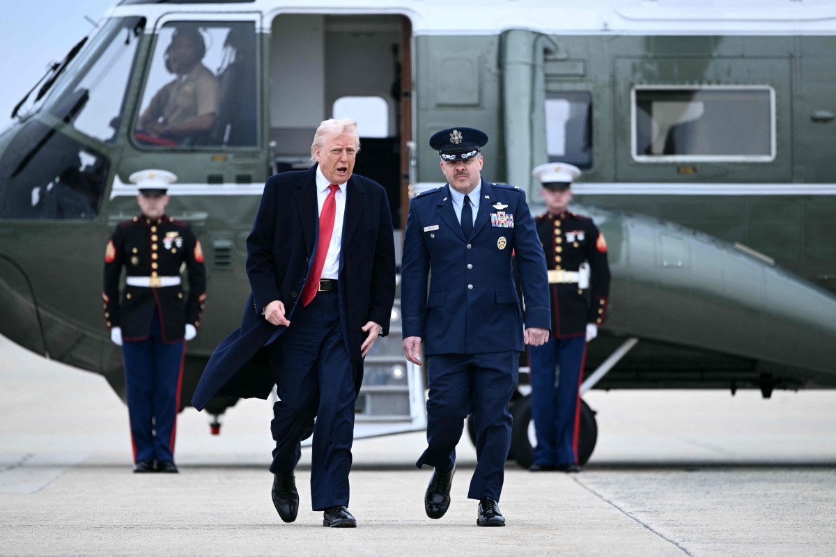US President Donald Trump walks to board Air Force One at Joint Base Andrews in Maryland on March 14, 2025. Trump is spending the weekend at his Florida Mar-a-Lago resort. (Photo by Brendan SMIALOWSKI / AFP)
