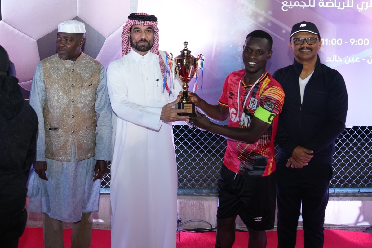 NHRC Secretary-General H E Sultan bin Hassan Al Jamali awarding the trophy. Ambassador of Uganda H E Mohammed Baswari Kezaala (first left) is also seen.