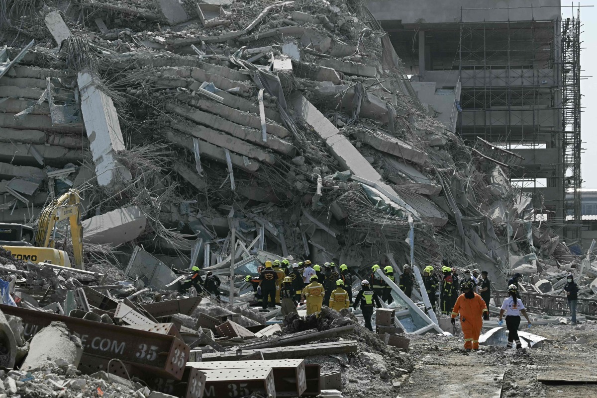 Rescue teams are seen at a construction site where a building collapsed in Bangkok on March 28, 2025, after an earthquake. Photo by Lillian SUWANRUMPHA / AFP