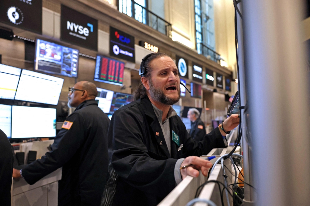 Traders work at the American Stock Exchange (AMEX) on the floor of the New York Stock Exchange (NYSE) at the closing bell in New York City, on April 4, 2025. (Photo by Timothy A. Clary / AFP)