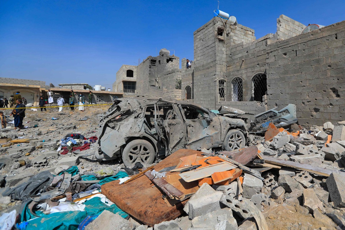 People inspect the site of a reported US airstrike in Sanaa, a day after the attack, on April 7, 2025. (Photo by Mohammed HUWAIS / AFP)
