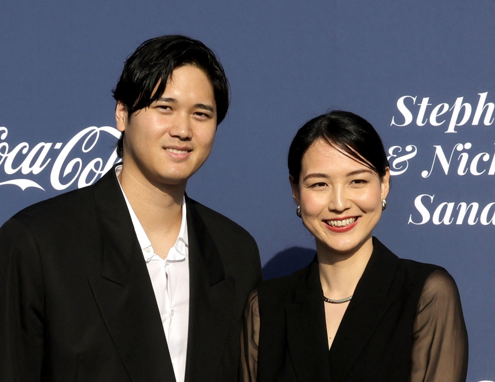 (Files) Shohei Ohtani (L) and Mamiko Tanaka at the Los Angeles Dodgers Foundation's 2024 Blue Diamond Gala at Dodger Stadium on May 2, 2024 in Los Angeles, California. (Photo by Kevin Winter / Getty Images North America / AFP)